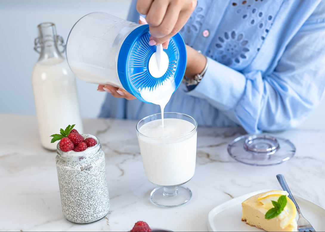 Kefirko üvegből szűrőfedélen át pohárba öntött házi tejkefir